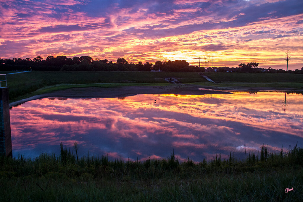 An orange and purple sunset over water at E. L. Huie. © E. Danielle Bunch