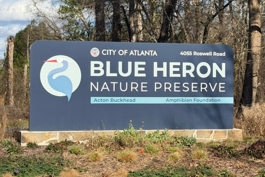 A large sign with the words "City of Atlanta, Blue Heron Nature Preserve" and an image of a Great Blue Heron.
